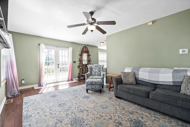 living room with french doors, dark hardwood / wood-style floors, and ceiling fan