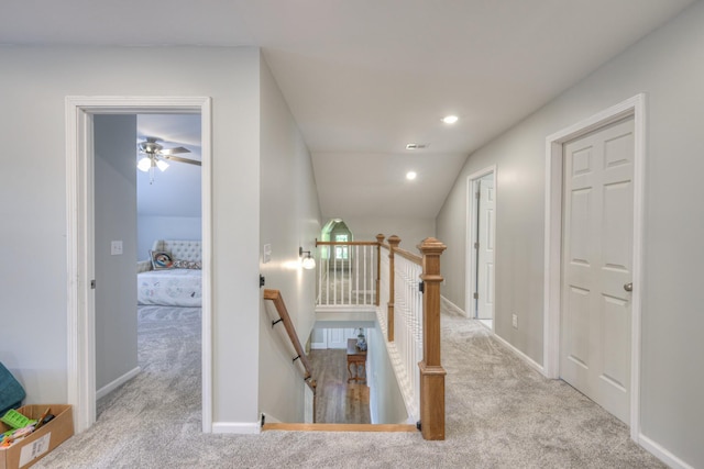 stairway featuring carpet and lofted ceiling