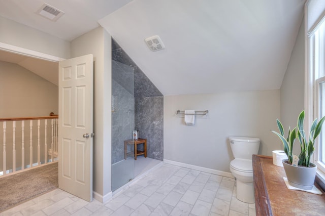 bathroom with toilet, walk in shower, and vaulted ceiling