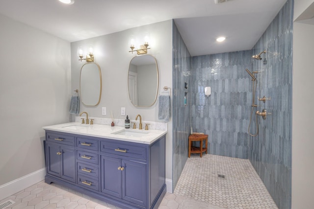 bathroom featuring tile patterned floors, vanity, and tiled shower