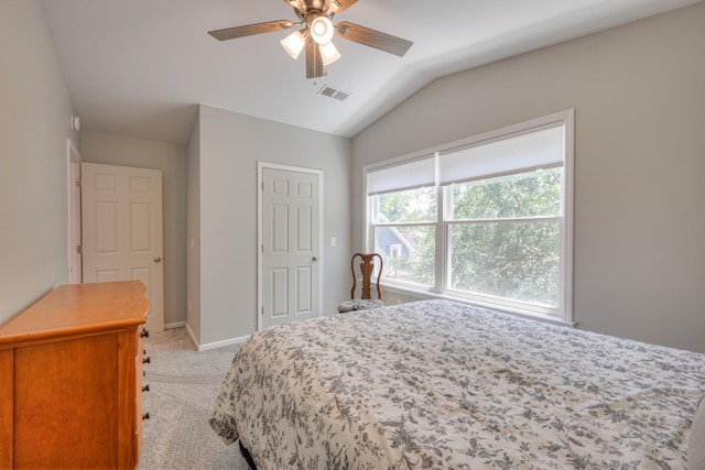 bedroom featuring ceiling fan, light carpet, and vaulted ceiling