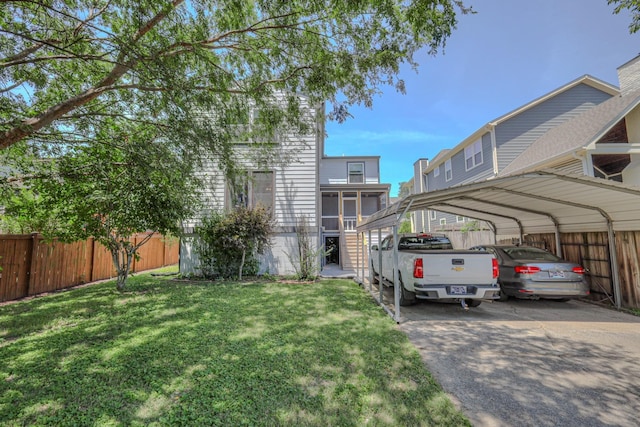 view of vehicle parking featuring a lawn and a carport