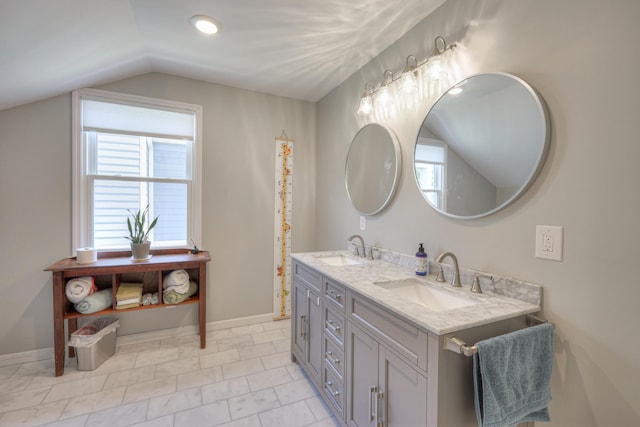 bathroom with vanity and lofted ceiling