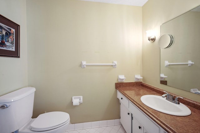 bathroom featuring tile patterned floors, vanity, and toilet