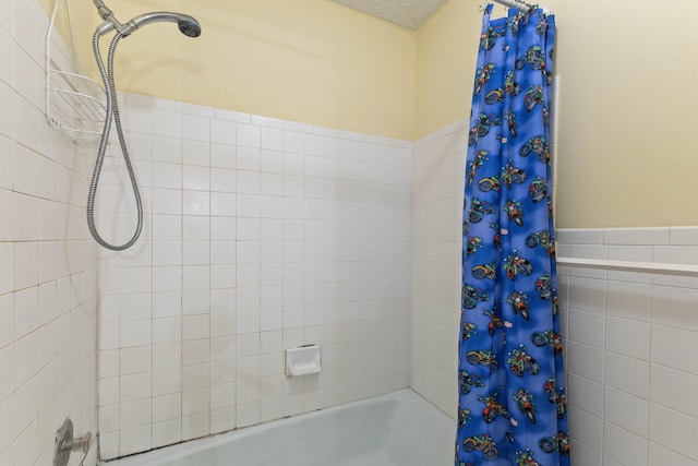 bathroom featuring a textured ceiling and shower / bath combo