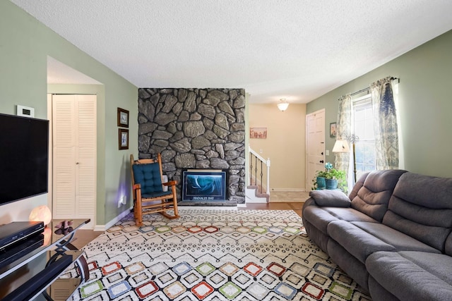 living room featuring a fireplace and a textured ceiling