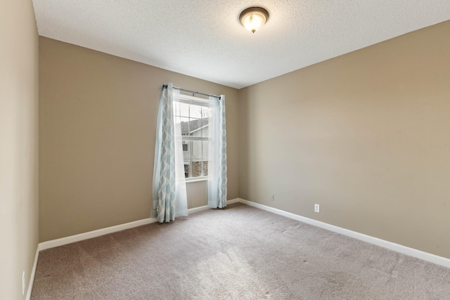 empty room featuring carpet flooring and a textured ceiling