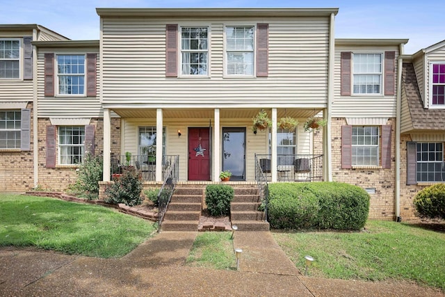 townhome / multi-family property with a porch