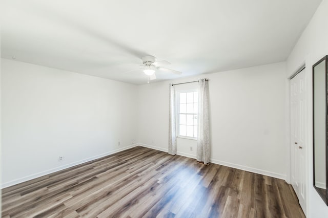 spare room featuring hardwood / wood-style flooring and ceiling fan