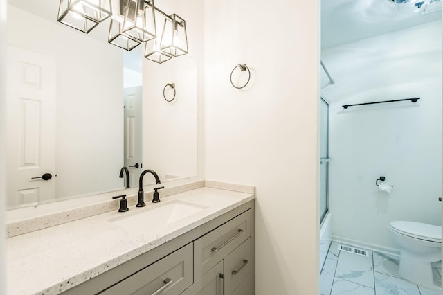 full bathroom with vanity, toilet, and combined bath / shower with glass door