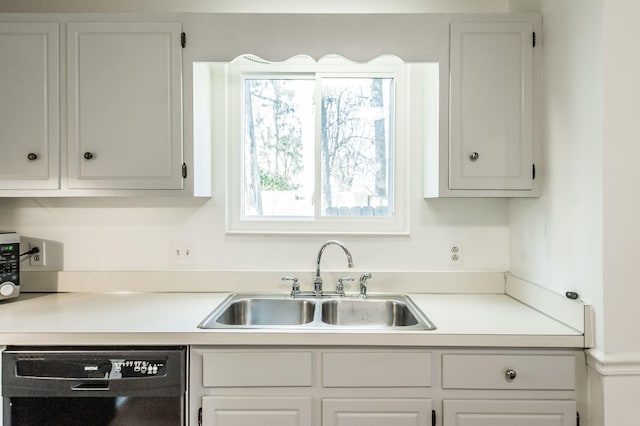 kitchen featuring white cabinetry, sink, and black dishwasher