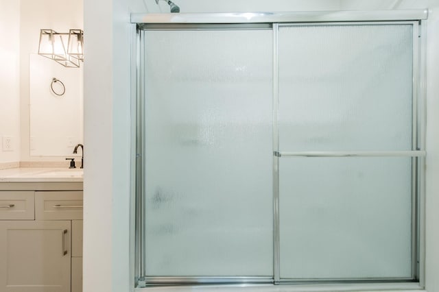 bathroom featuring vanity and a shower with shower door