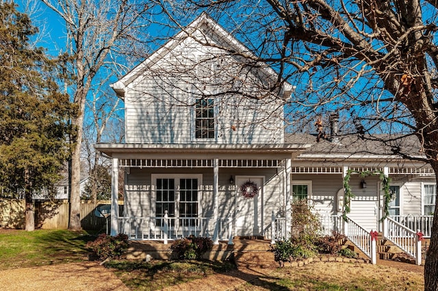 view of property with covered porch and a front lawn