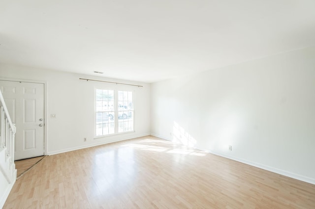 spare room with light hardwood / wood-style flooring