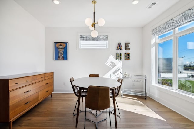 dining space with a chandelier and dark wood-type flooring