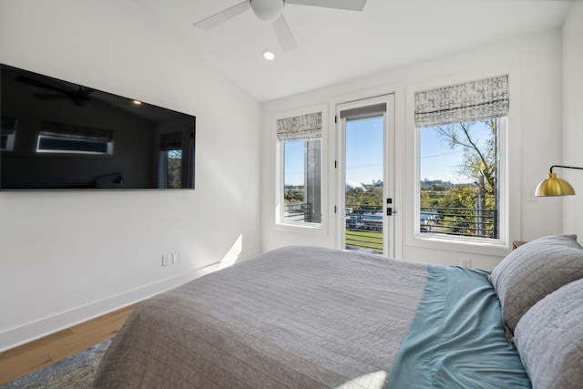 bedroom with hardwood / wood-style flooring, ceiling fan, and lofted ceiling