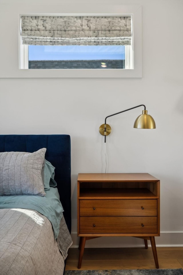 bedroom with dark hardwood / wood-style floors