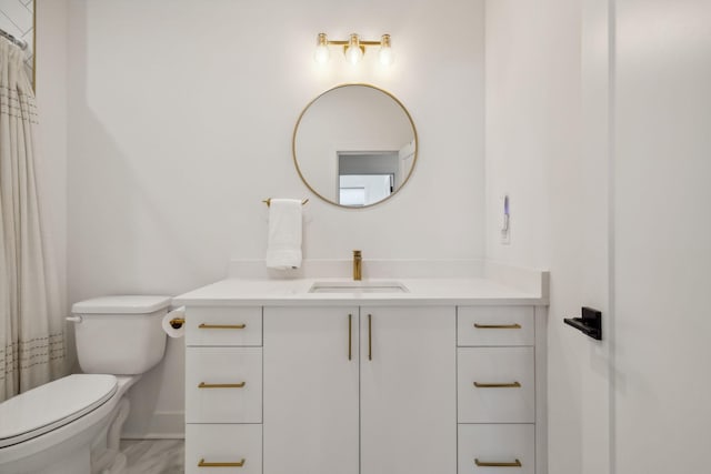 bathroom featuring vanity, toilet, and walk in shower