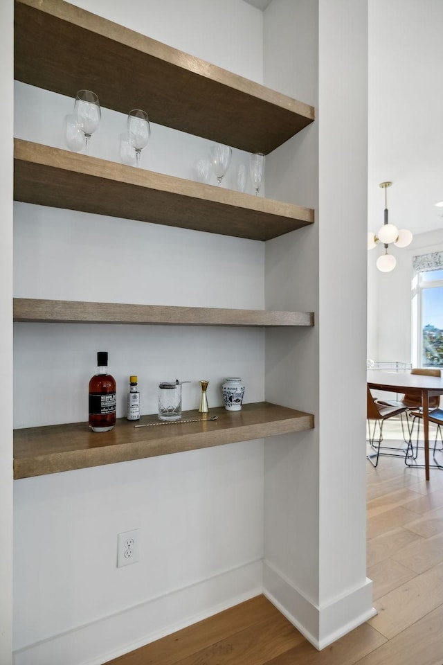 bar with wood-type flooring