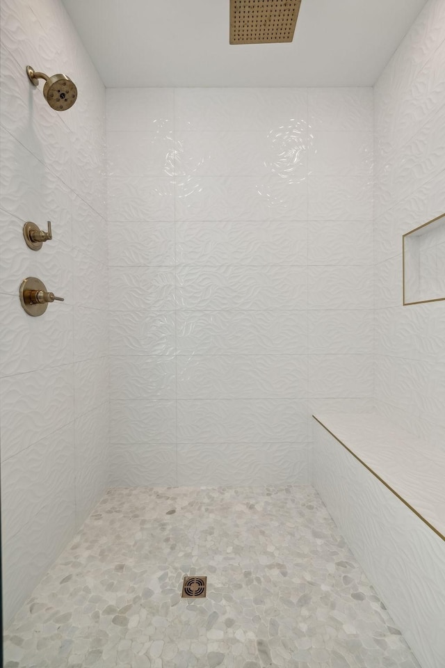 bathroom with a tile shower