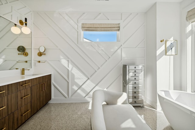 bathroom featuring vanity and a bath