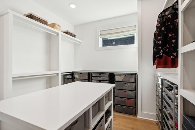 spacious closet featuring light wood-type flooring and beverage cooler