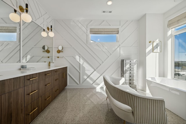 bathroom with a bathing tub and vanity