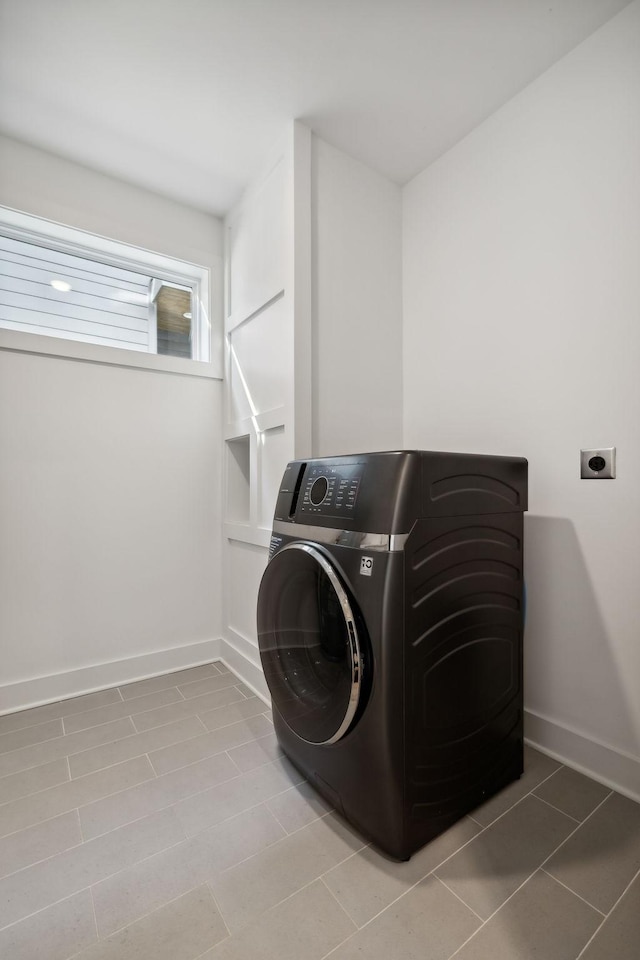 washroom with tile patterned flooring and washer / dryer