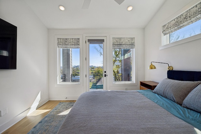 bedroom with access to outside, multiple windows, ceiling fan, and light hardwood / wood-style flooring