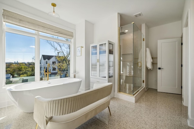 bathroom featuring independent shower and bath