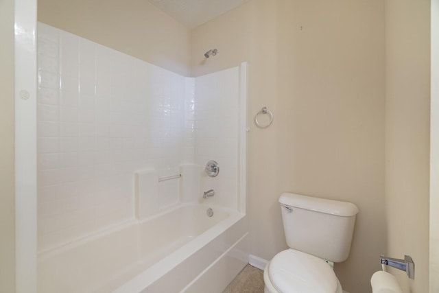 bathroom featuring tile patterned flooring, bathtub / shower combination, and toilet