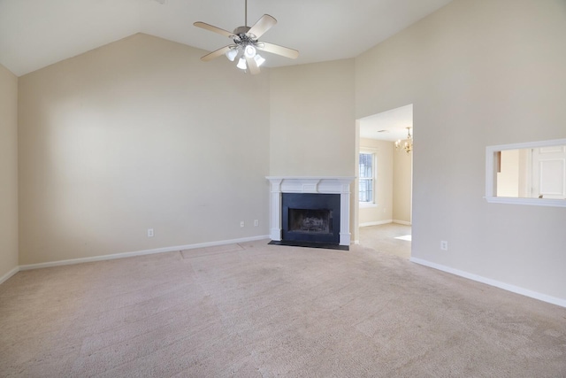 unfurnished living room featuring light carpet, ceiling fan with notable chandelier, and high vaulted ceiling