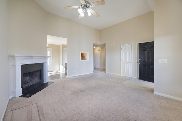 unfurnished living room featuring ceiling fan, light colored carpet, and high vaulted ceiling