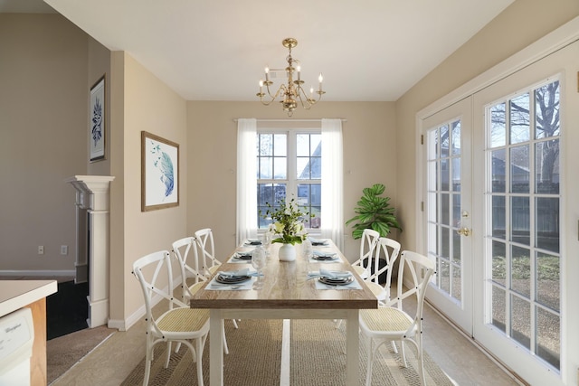 dining room featuring a notable chandelier and french doors