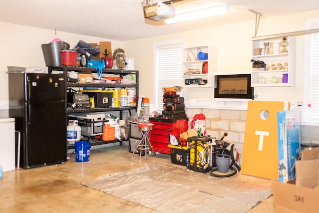 garage with black refrigerator and a garage door opener