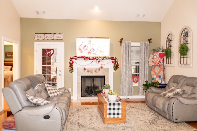 living room with hardwood / wood-style floors and a tile fireplace