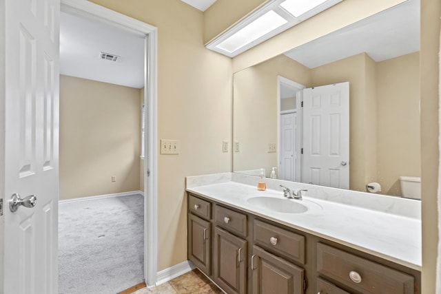 bathroom featuring vanity and toilet