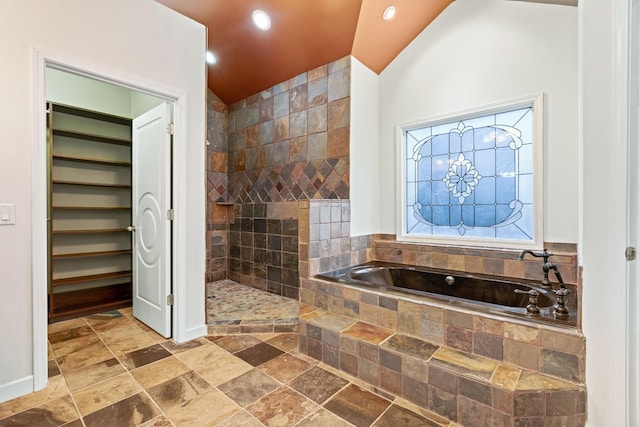 bathroom featuring independent shower and bath