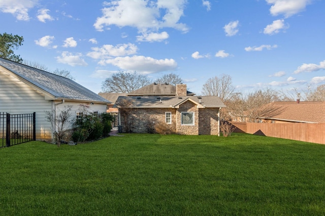 rear view of property with a lawn