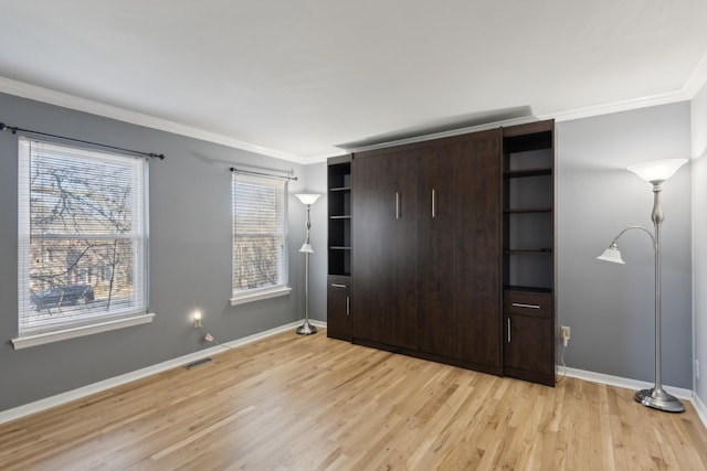 unfurnished bedroom with light wood-type flooring and crown molding