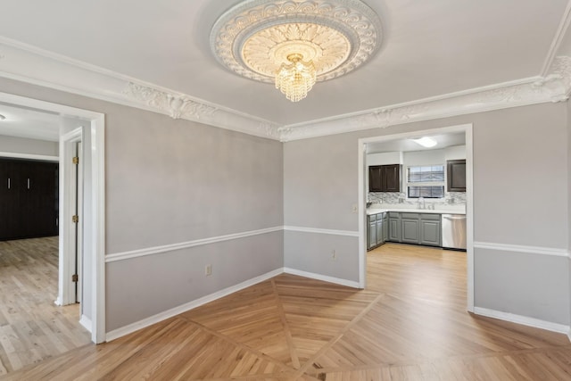 interior space featuring ornamental molding, sink, and a chandelier