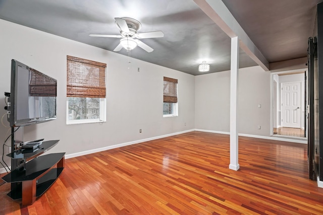 living room featuring hardwood / wood-style floors and ceiling fan