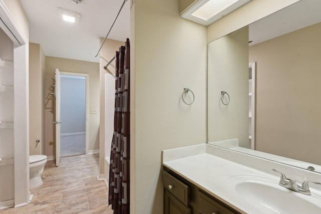 bathroom featuring vanity and toilet