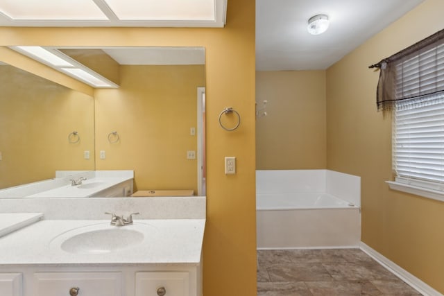 bathroom with a tub to relax in and vanity