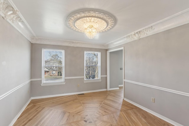 unfurnished room with ornamental molding and parquet flooring