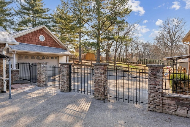 view of gate with a garage