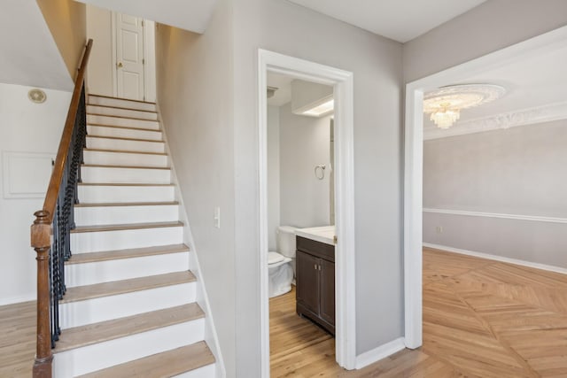 staircase featuring a chandelier