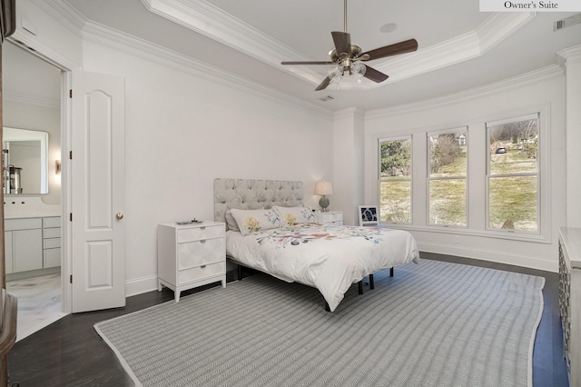 bedroom with dark hardwood / wood-style flooring, ceiling fan, a tray ceiling, and ornamental molding