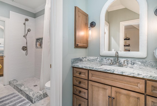 bathroom featuring toilet, a tile shower, crown molding, and vanity