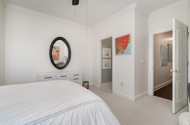 carpeted bedroom featuring ornamental molding and ceiling fan